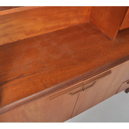 257 - Beautility - A retro vintage 1970s teak wood highboard / sideboard credenza having a shelved three q... 