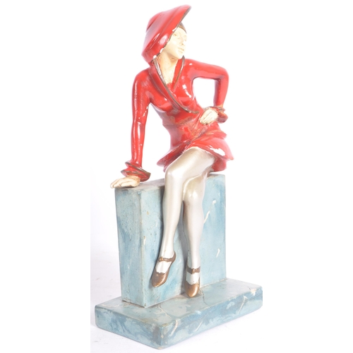 26 - A vintage 20th Century Art Deco hand painted plaster figure in the form a well dressed lady perched ... 