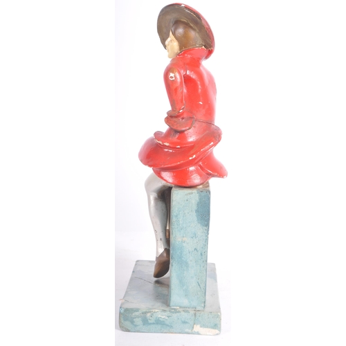 26 - A vintage 20th Century Art Deco hand painted plaster figure in the form a well dressed lady perched ... 