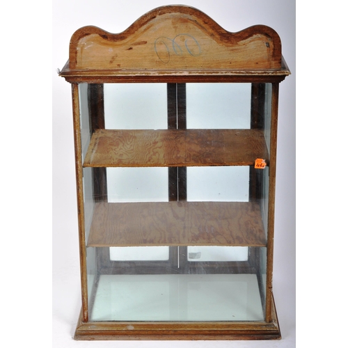 262 - An early 20th Century mahogany framed counter / table top shop display glazed cabinet having a pedim... 