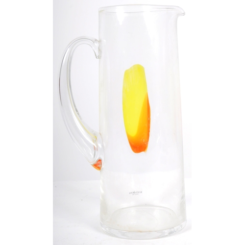 263 - Kosta Boda - A late 20th Century Swedish clear glass water jug having a central yellow and orange ab... 