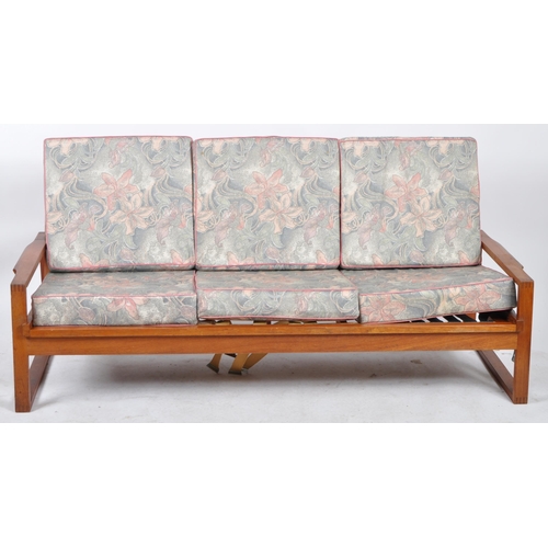 265 - A retro mid 20th Century teak framed three seater sofa settee having a spindle backrests with webbin... 