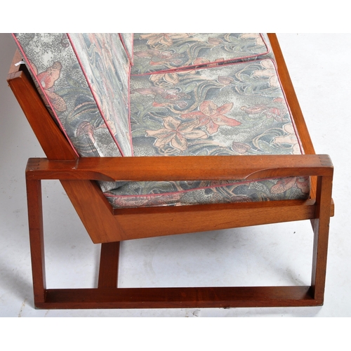 265 - A retro mid 20th Century teak framed three seater sofa settee having a spindle backrests with webbin... 