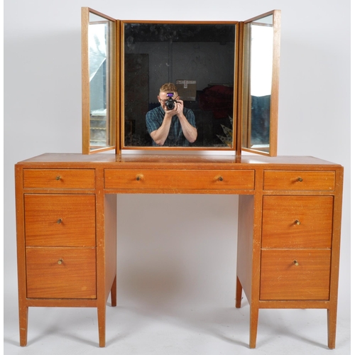 284 - Loughborough Furniture - A retro mid 20th Century 1960s teak dressing table desk having a triptych o... 