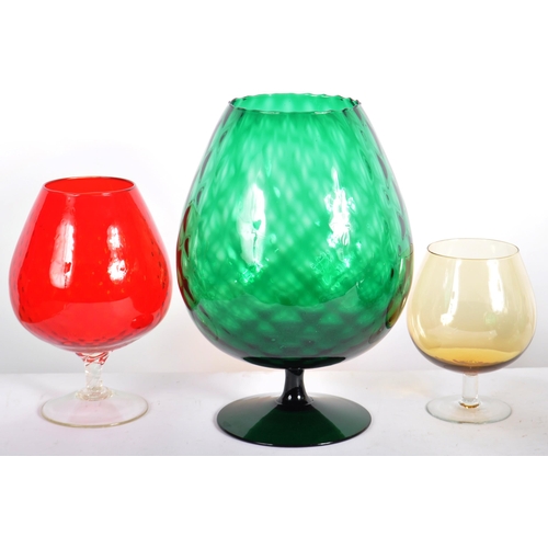 286 - Three graduating mid Century brandy / balloon glass vases / centrepieces. The largest finished in gr... 