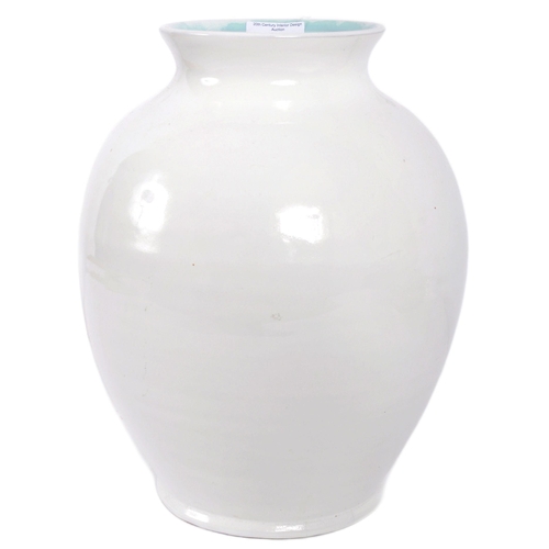 293 - C H Brannam - A retro 20th Century studio art pottery vase of bulbus ribbed form having a white glaz... 