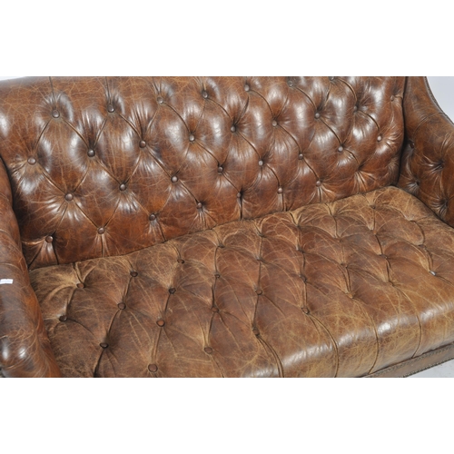 30 - A 20th Century brown leather Chesterfield button backed three seater sofa settee with brass stud det... 