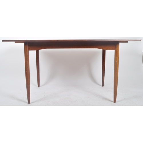 318 - A retro mid 20th Century Danish influenced teak dining table and matching chairs. The extending dini... 