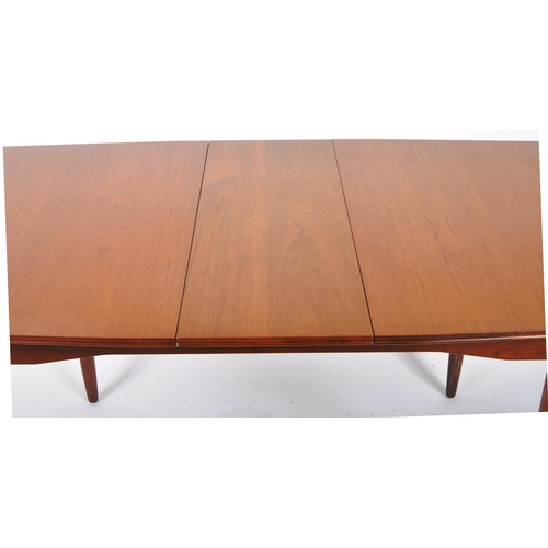 318 - A retro mid 20th Century Danish influenced teak dining table and matching chairs. The extending dini... 