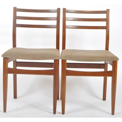 318 - A retro mid 20th Century Danish influenced teak dining table and matching chairs. The extending dini... 