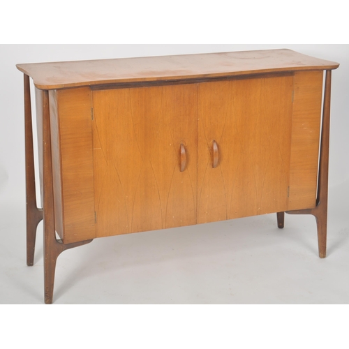 322 - Everest - Helix - A retro mid 20th Century teak and walnut sideboard credenza having a shaped top wi... 