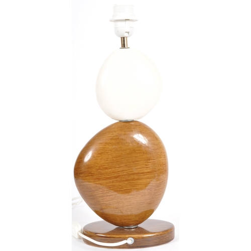 327 - A contemporary designer ceramic pebble table lamp light in two tones with all raised on an oval cera... 