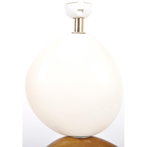 327 - A contemporary designer ceramic pebble table lamp light in two tones with all raised on an oval cera... 