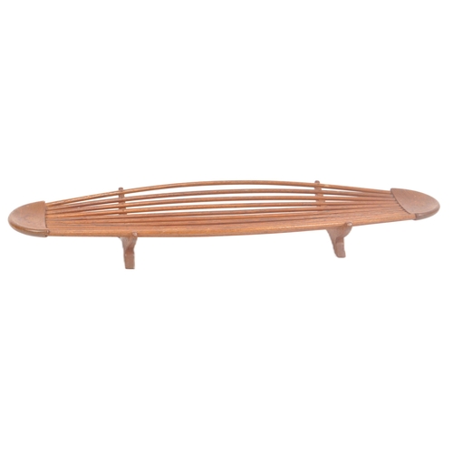 33 - A retro mid 20th Century Danish teak fruit bowl of elongated form having shaped ends with central sp... 