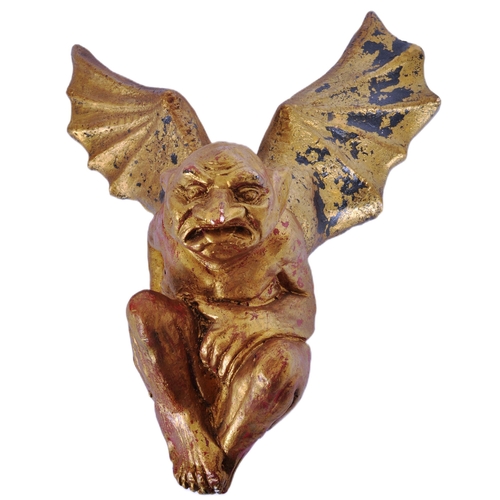 36 - A vintage 20th Century gilt plaster gargoyle wall plaque / figure having wings open moulded in a hun... 