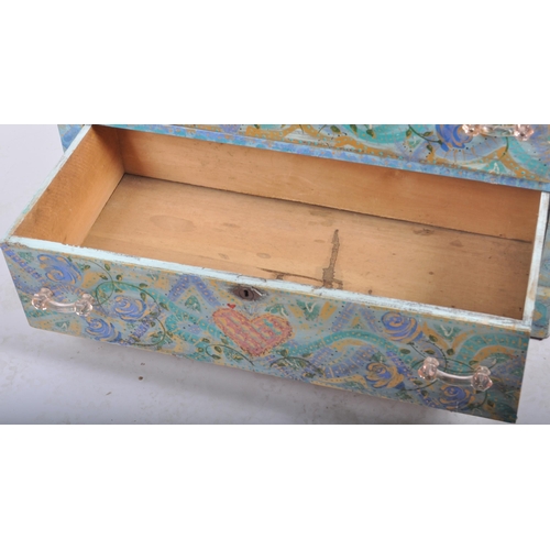 372 - A 20th Century painted pine chest of drawers having a three drawers with light blue coloured ground ... 