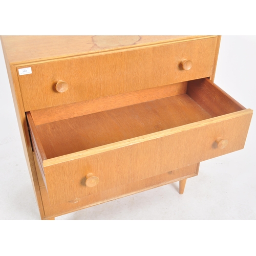 382 - G Plan - A retro mid 20th Century oak chest of drawers having a straight bank four drawers each with... 