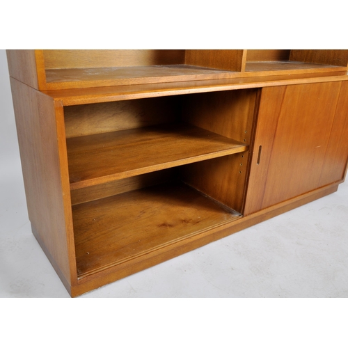 414 - Simplex - A retro 20th Century two part bookcase cabinet having an open bookcase top with adjustable... 