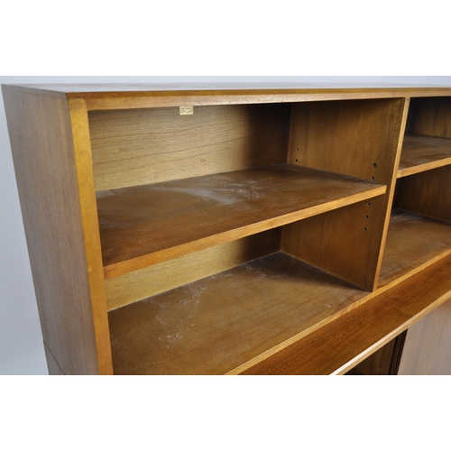 414 - Simplex - A retro 20th Century two part bookcase cabinet having an open bookcase top with adjustable... 