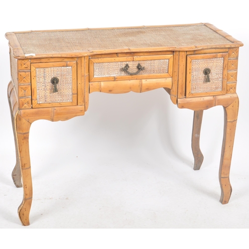 42 - A vintage early 20th Century breakfront bamboo desk / dressing table having a central drawer over th... 