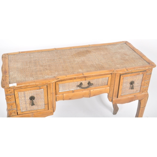 42 - A vintage early 20th Century breakfront bamboo desk / dressing table having a central drawer over th... 