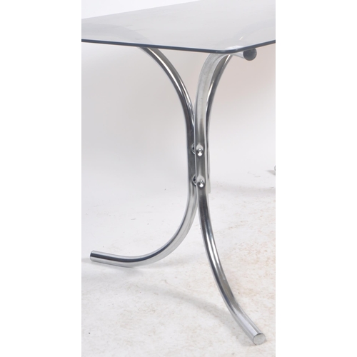 424 - A retro vintage 20th Century British design chrome and smoked glass top dining table having a rounde... 