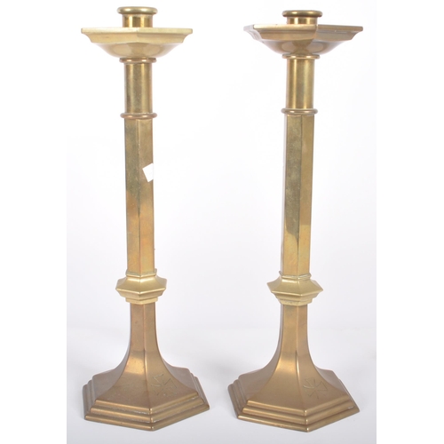 426 - A matching pair of mid 20th Century solid brass candlestick holders of ecclesiastical influence havi... 