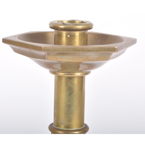 426 - A matching pair of mid 20th Century solid brass candlestick holders of ecclesiastical influence havi... 