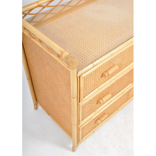 427 - A retro vintage mid 20th Century 1970s bamboo & rattan chest of drawers. The chest having a gallery ... 