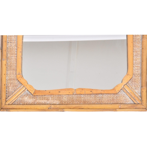 43 - A vintage early 20th Century bamboo and cane wall hanging mirror having a single shaped mirror plate... 