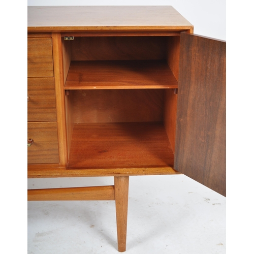 435 - Gordon Russell - A retro mid 20th Century teak sideboard credenza having a central bank of three dra... 