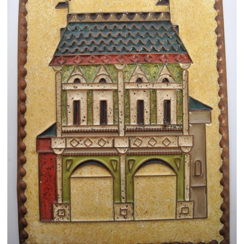 443 - Two retro 20th Century 1970s enameled copper wall plaques with one depicting a gatehouse and the oth... 