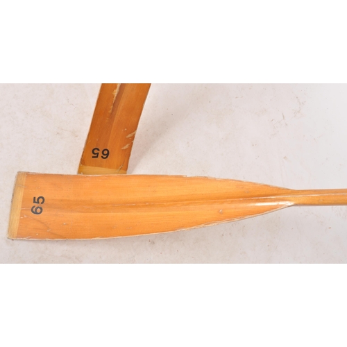 447 - A decorative pair of 20th Century vintage boat rowing oars / paddles of pine construction having ori... 