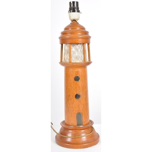 448 - A retro mid 20th Century 1960s teak table lamp light in the form of a lighthouse having an etched fr... 