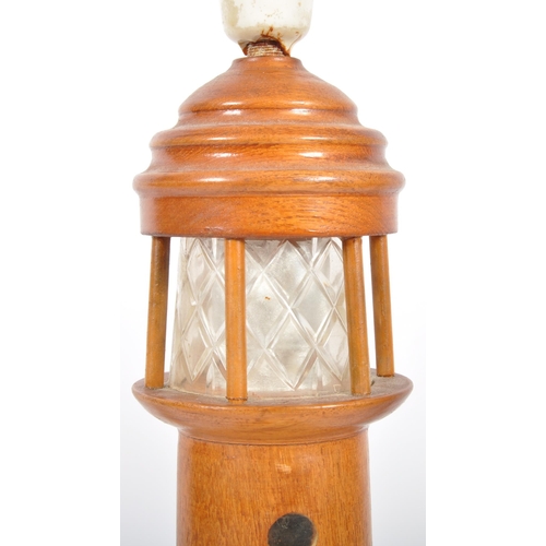 448 - A retro mid 20th Century 1960s teak table lamp light in the form of a lighthouse having an etched fr... 