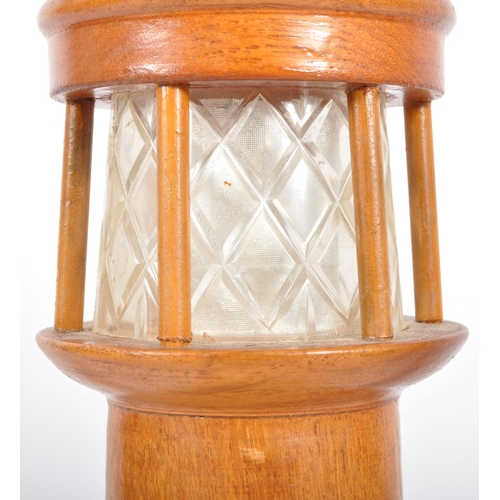 448 - A retro mid 20th Century 1960s teak table lamp light in the form of a lighthouse having an etched fr... 