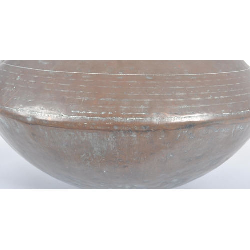 462 - An 18th Century Indonesian copper serving pot of bulbous circular form having a flat circular rim ov... 