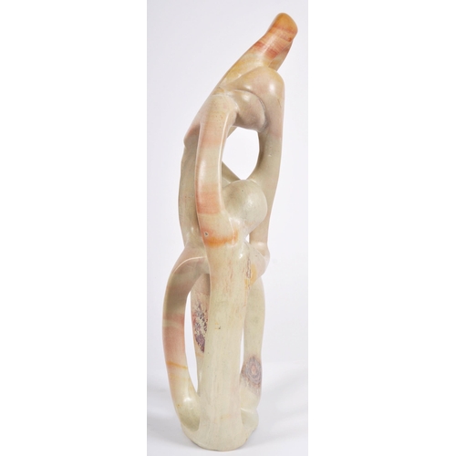 473 - A retro 20th Century carved soapstone abstract figure group sculpture depicting interwoven figures. ... 