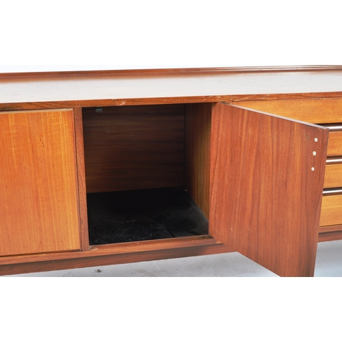 50 - A large mid 20th Century Danish influenced teak wood sideboard credenza having a dual bank of eight ... 