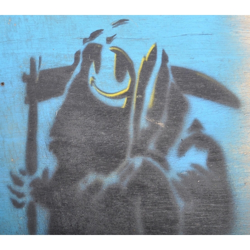 519 - A Contemporary Banksy stencil on board depicting the smiling grim reaper. Measures approx; 45cm x 40... 