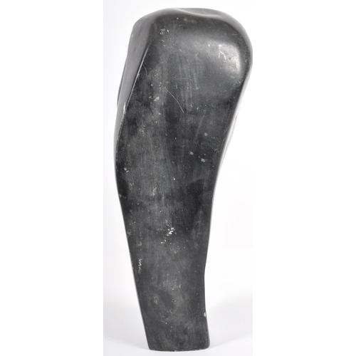 52 - Eddie Masaya (b.1960) - A 20th Century African carved stone sculpture in the form of a stylized figu... 