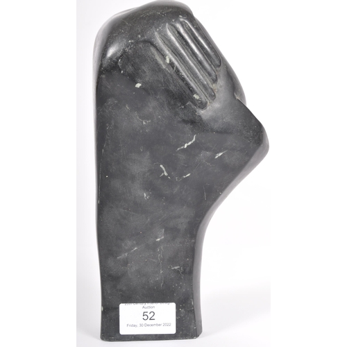 52 - Eddie Masaya (b.1960) - A 20th Century African carved stone sculpture in the form of a stylized figu... 