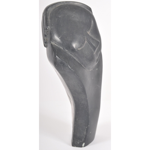 52 - Eddie Masaya (b.1960) - A 20th Century African carved stone sculpture in the form of a stylized figu... 