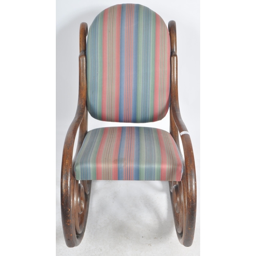 524 - An early 20th Century bentwood rocking chair / armchair having a scrolled rocking fame with padded b... 