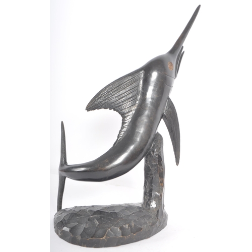 526 - A retro 20th Century ebonised wood hand carved sculpture in the form of a swordfish with carved deta... 