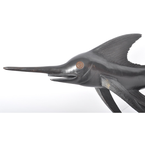 526 - A retro 20th Century ebonised wood hand carved sculpture in the form of a swordfish with carved deta... 