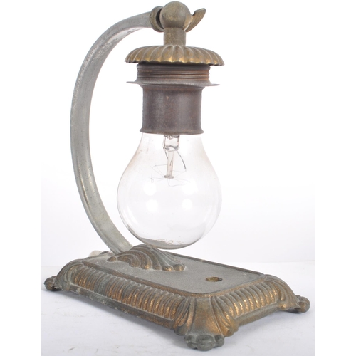 537 - A vintage 20th Century cast iron arc table / desk lamp light having a hanging bulb via and arched ar... 