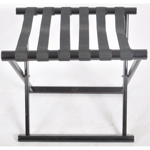 546 - A matching pair of Contemporary ebonised luggage rack stands with webbed tops and folding X-frame st... 