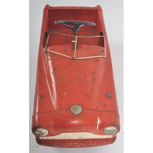 550 - Sharna Tri-ang Limited - A retro vintage 20th Century tinplate pedal car finished in red with white ... 