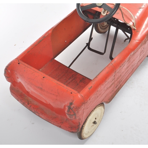 550 - Sharna Tri-ang Limited - A retro vintage 20th Century tinplate pedal car finished in red with white ... 